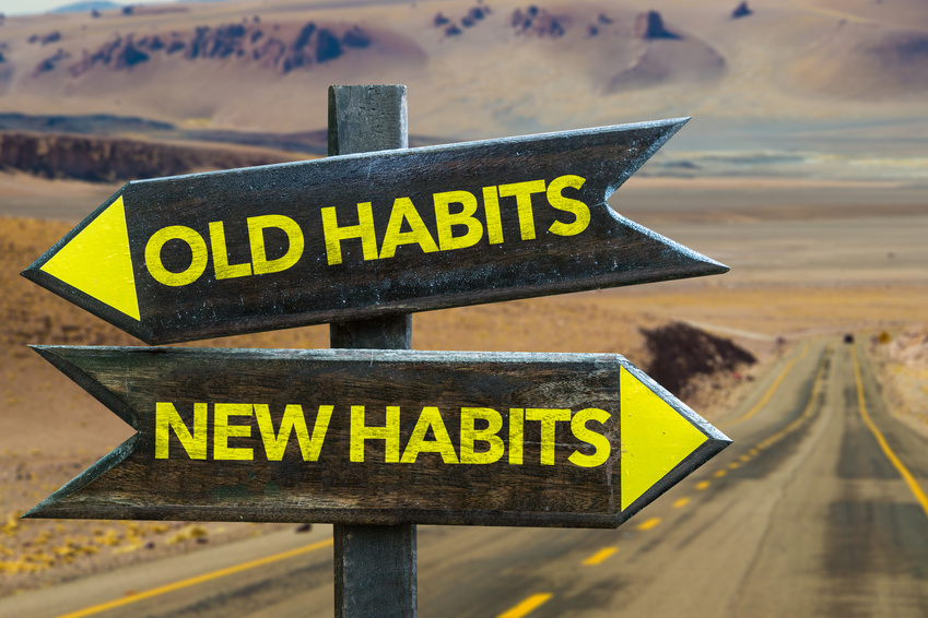 Old Habits – New Habits Signpost In A Desert Road Background
